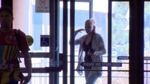 Alicia Lander arrives at court Wednesday wearing a hoodie. She's accused of committing a sexual act on an Air Canada plane last year. (CBC)